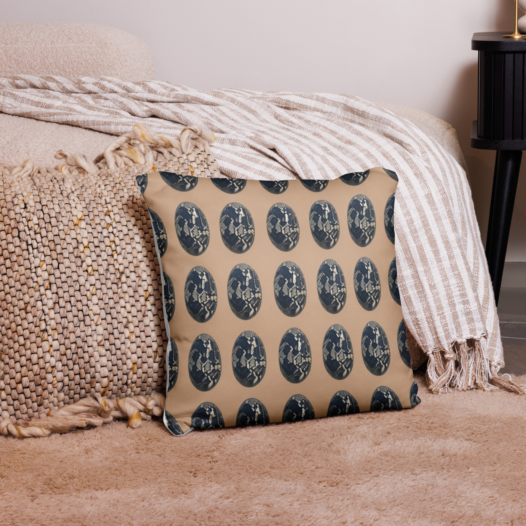Snake skin motif cushion with realistic reptilian scale pattern in brown and beige tones arranged in repeat design on neutral background