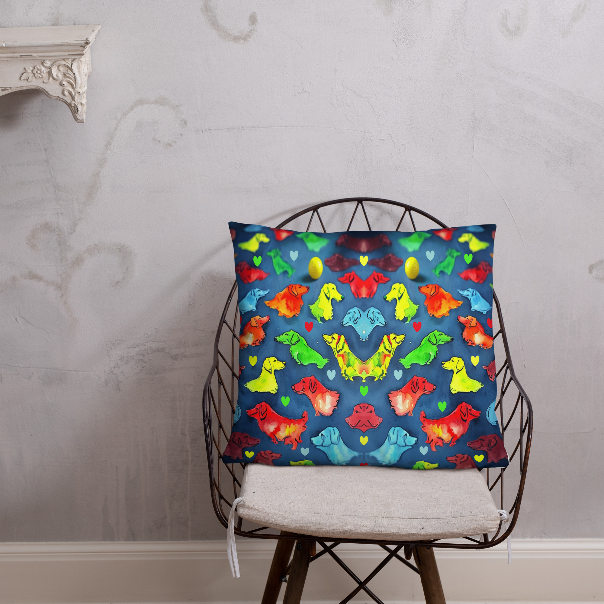Square decorative cushion with colorful dog silhouettes in rainbow colors arranged symmetrically against dark navy blue background