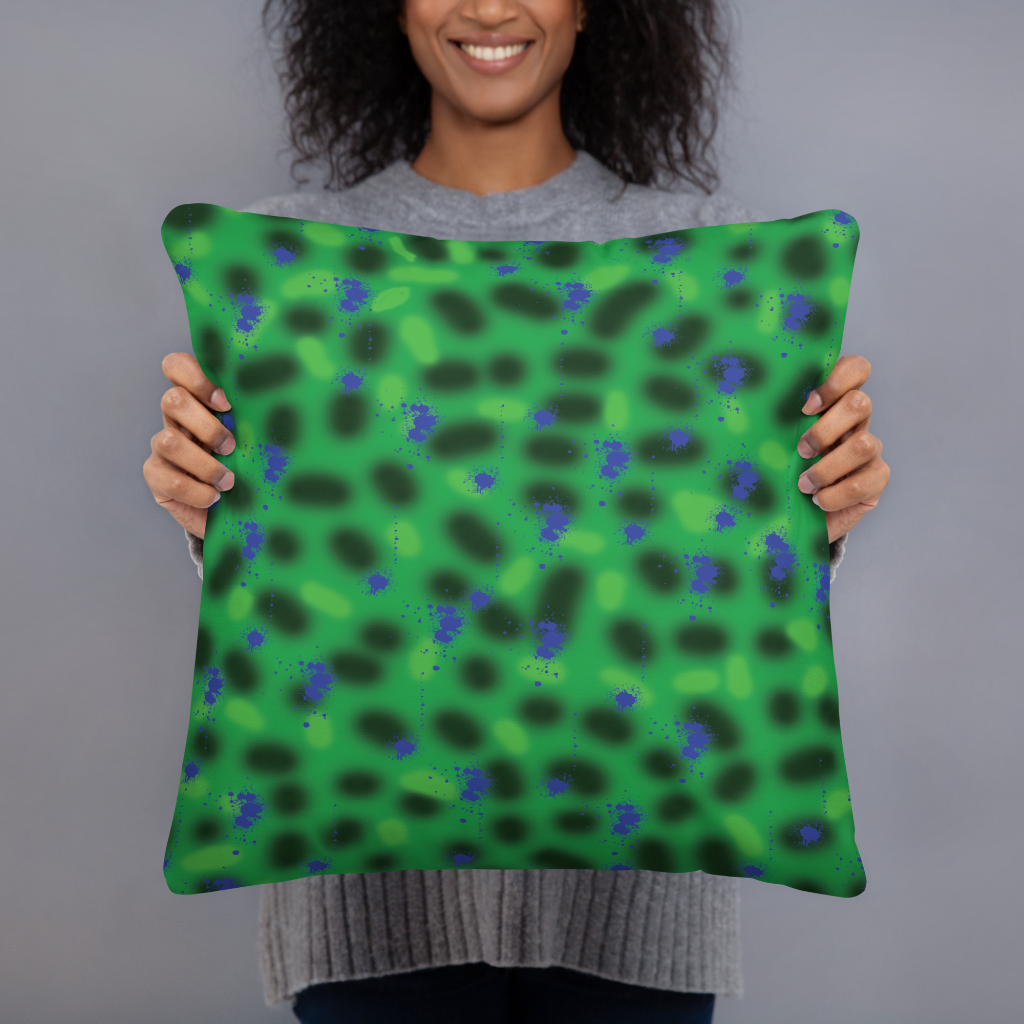 cushion with bright green background featuring scattered navy blue spots in organic abstract dot pattern