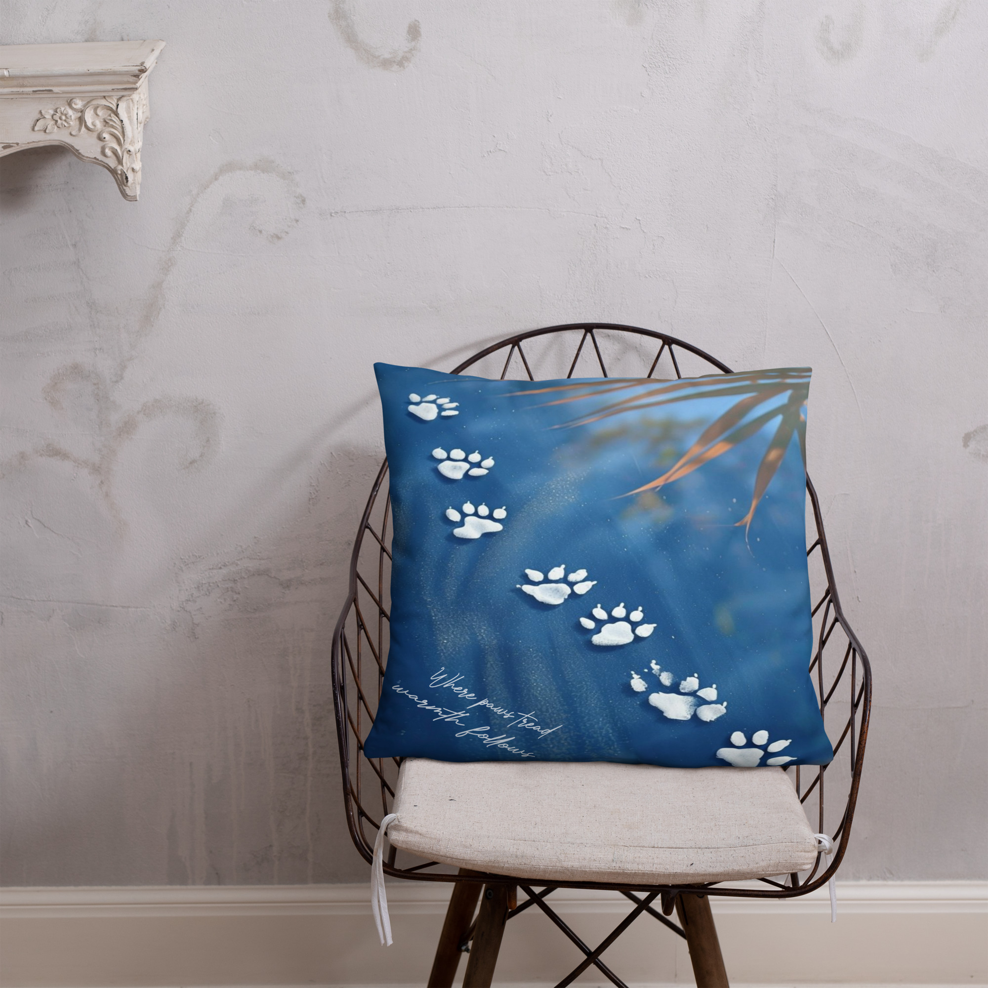 Square decorative cushion with white cat paw prints scattered across soft blue watercolor background creating cat walk pattern
