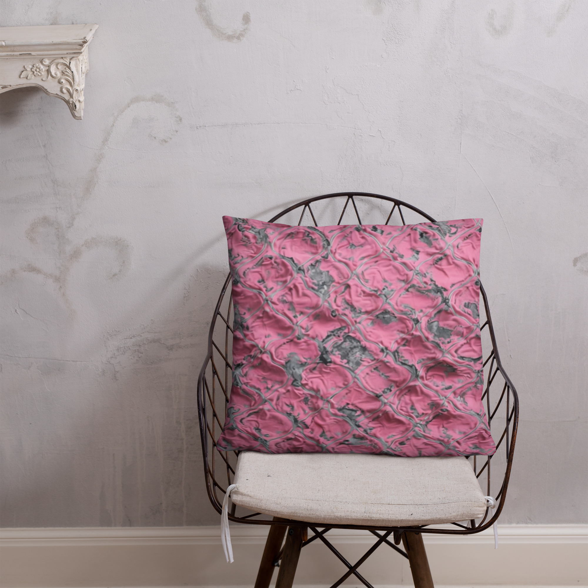 cushion with pink crinkled textured fabric surface creating abstract dimensional pattern in rose and magenta tones