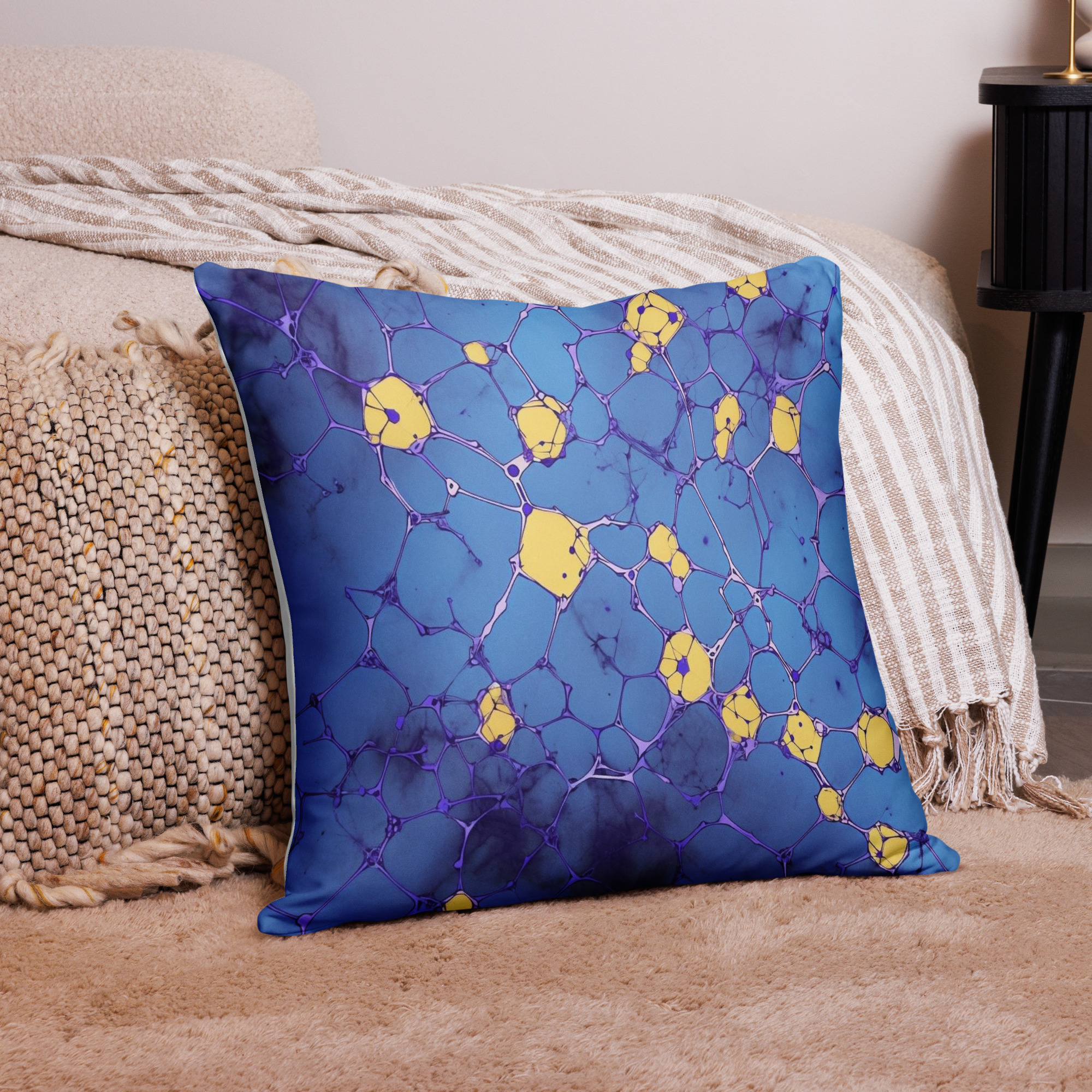 Blue accent pillow showing golden star motifs scattered across deep navy blue fabric background