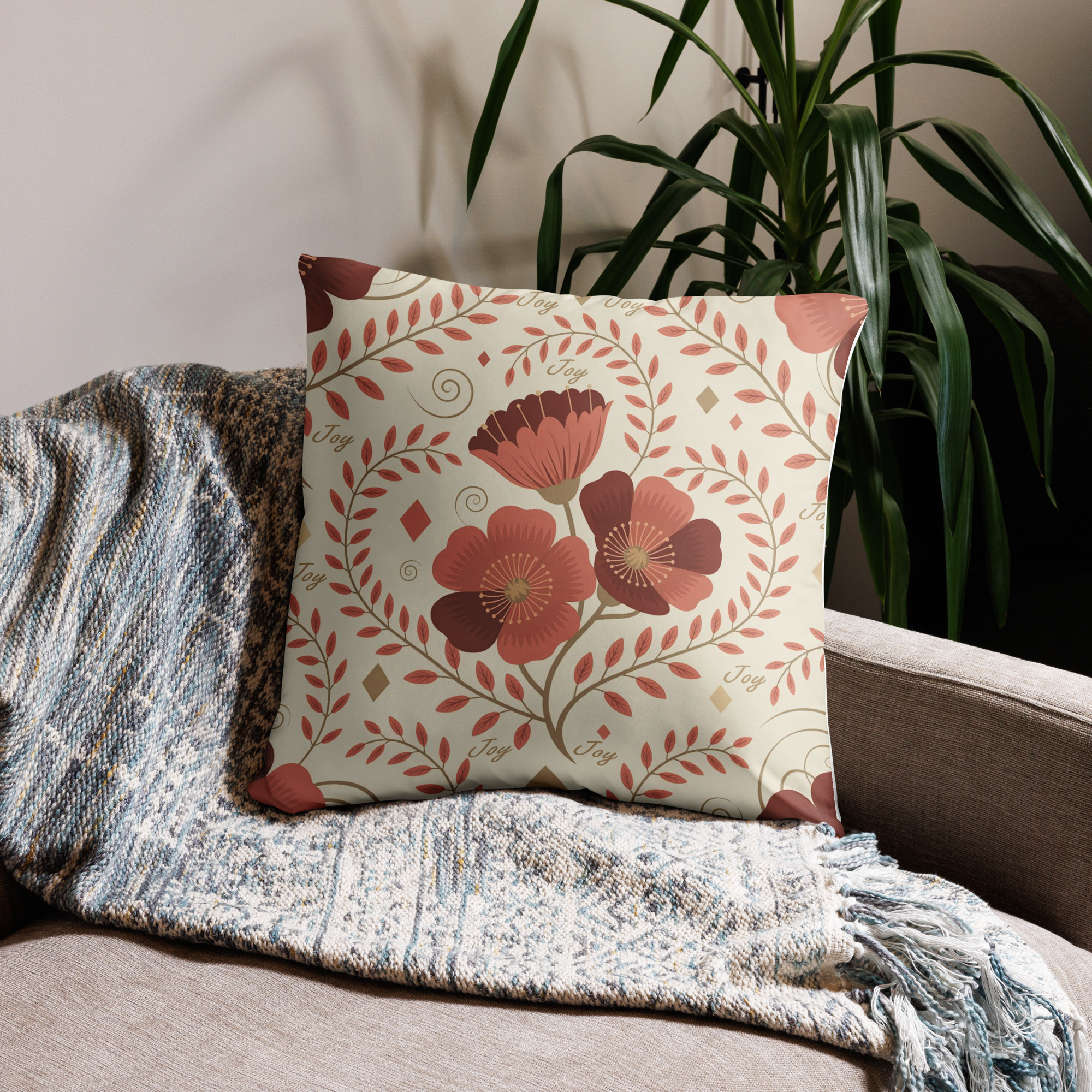 Botanical throw pillow showing autumn leaf pattern with burgundy and orange foliage on cream background