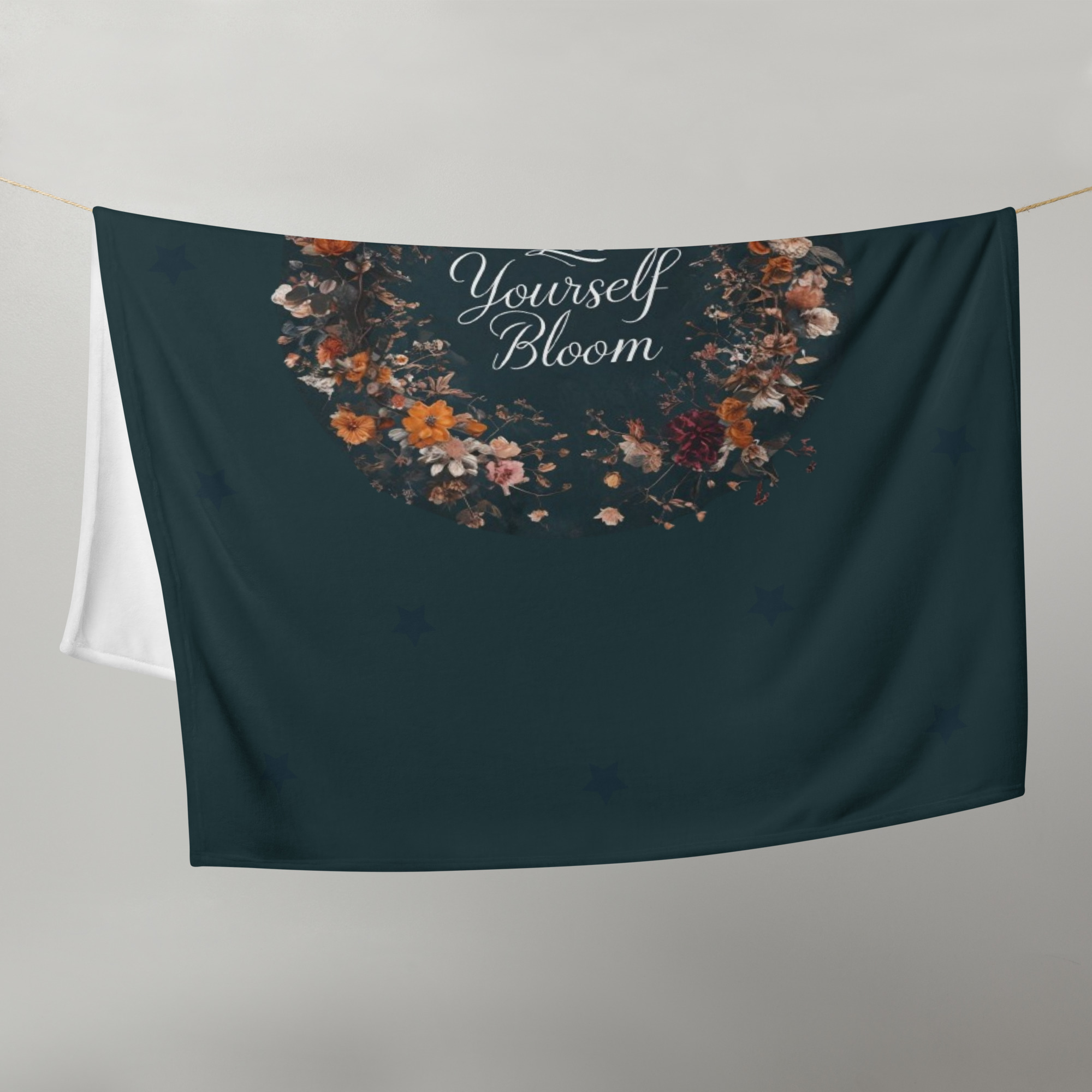 Dark teal throw blanket featuring "Let Your Heart Bloom" quote surrounded by decorative floral wreath design, perfect for inspirational home decor and cozy comfort.