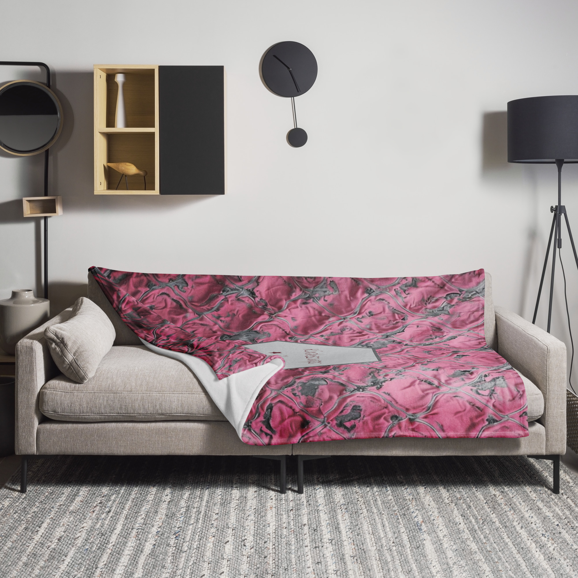 Pink floral fabric with rose pattern and white product label showing delicate blooms on textile material