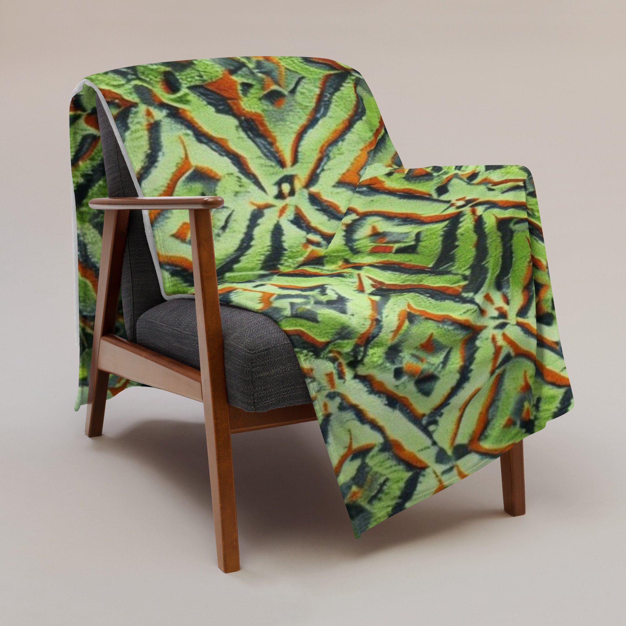 Green Ikat Blanket with bold geometric diamond patterns in green, orange, and blue.