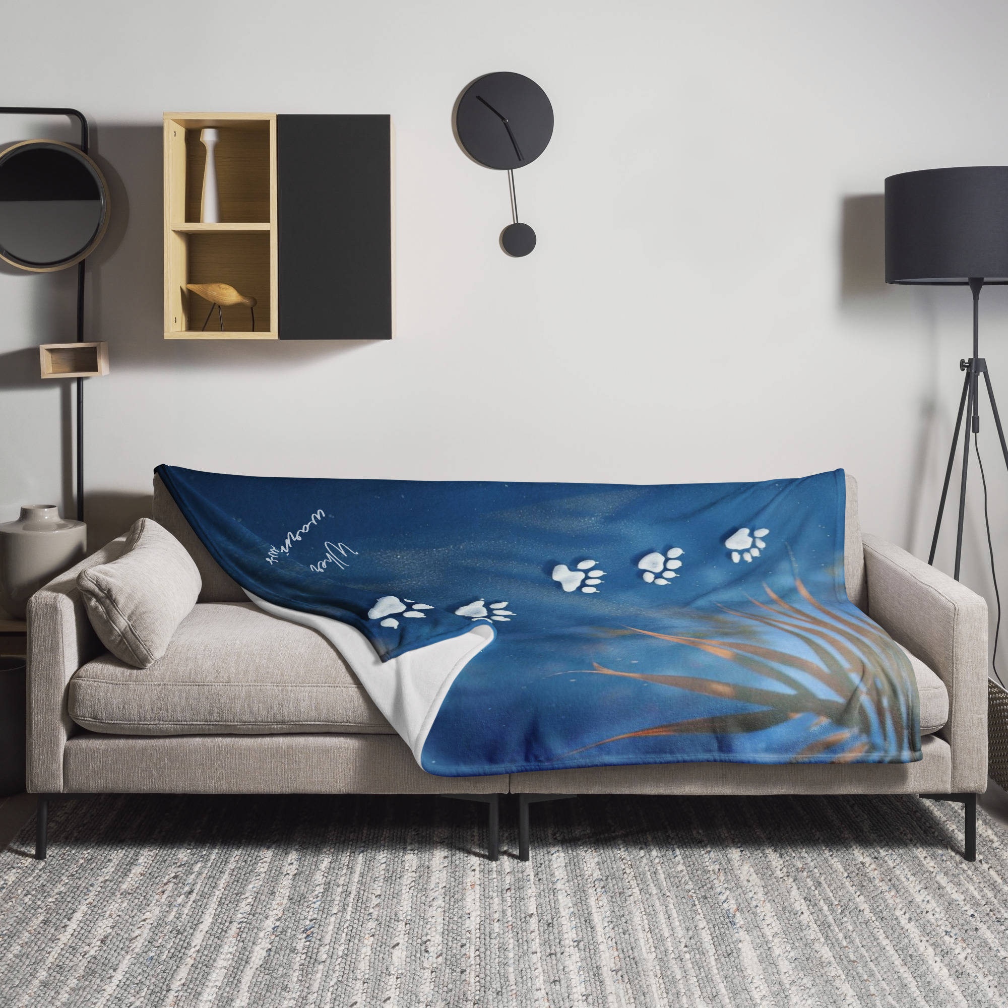 Safari wildlife blanket with white paw print trail design on blue background with plant elements