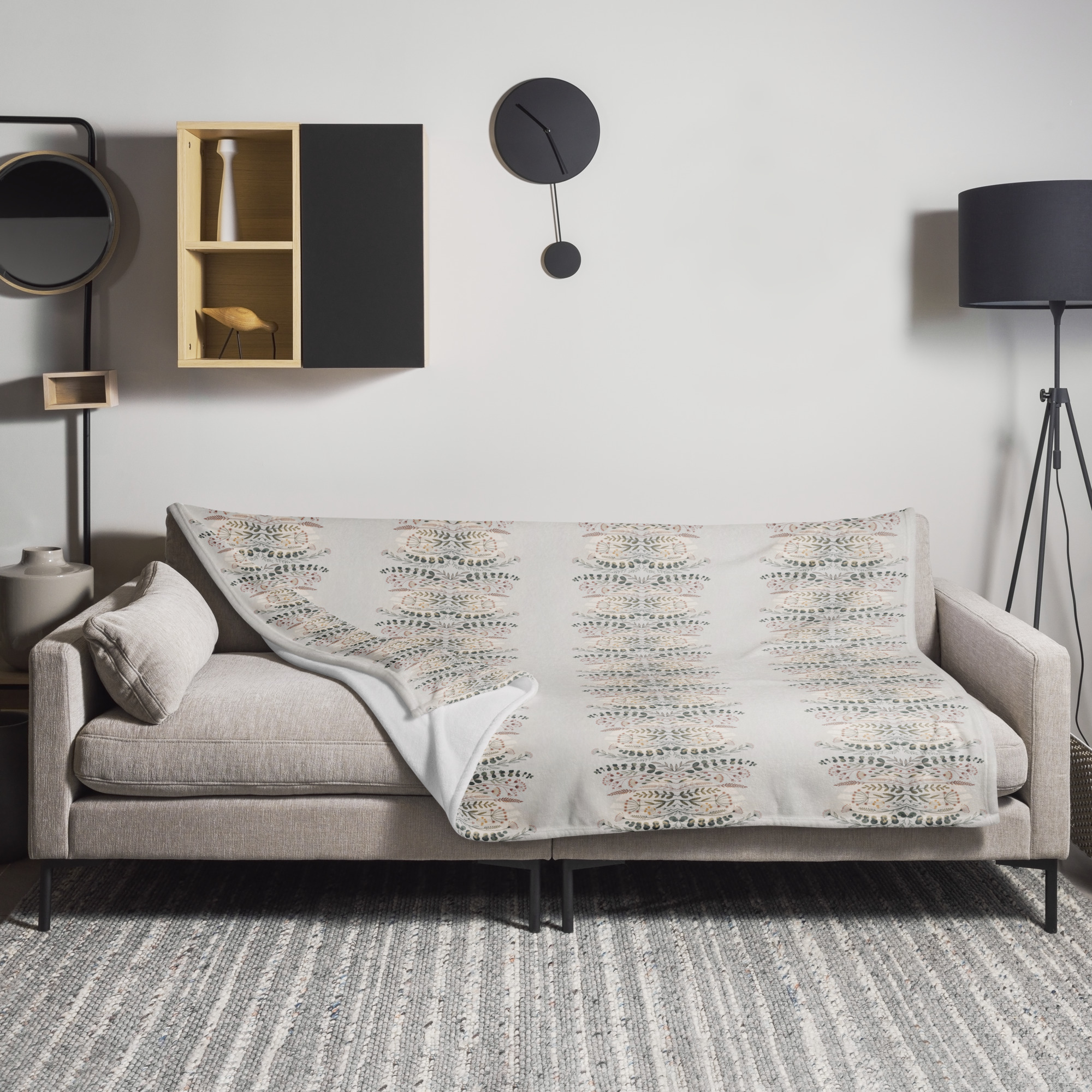 Geometric throw blanket featuring repeating diamond pattern in neutral beige and cream tones, displayed with corner folded to show texture and design detail.